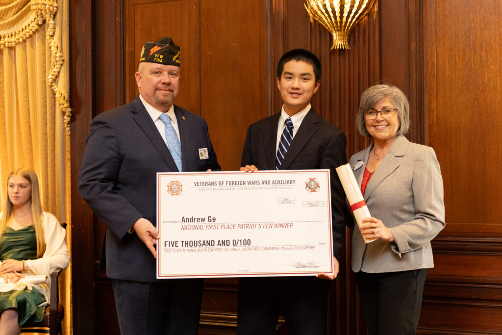 Andrew Ge holding up his check awarded for national first place patriot's pen winner.