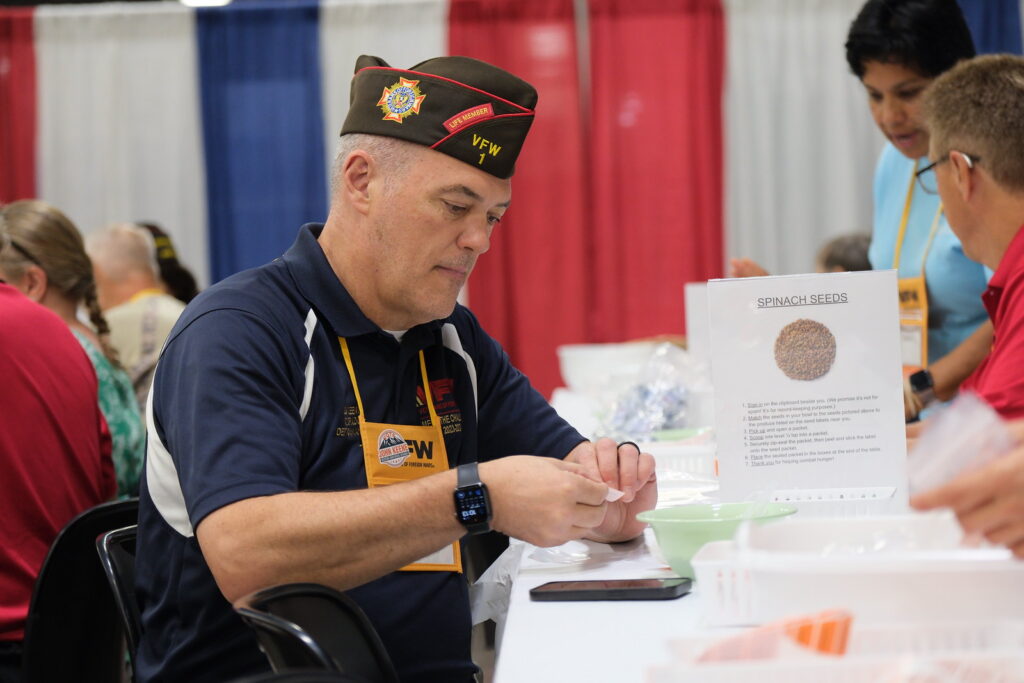 A veteran participates in a seed-packing activity, promoting community engagement and support for fellow veterans.