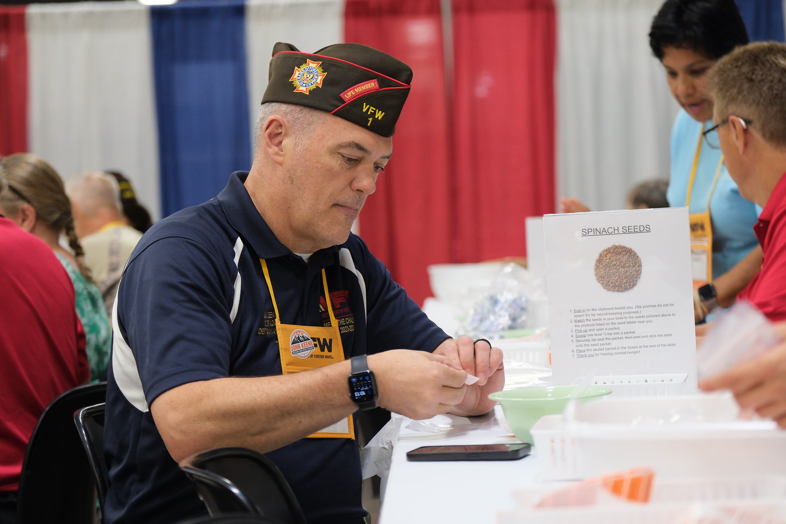 A veteran participates in a seed-packing activity, promoting community engagement and support for fellow veterans.