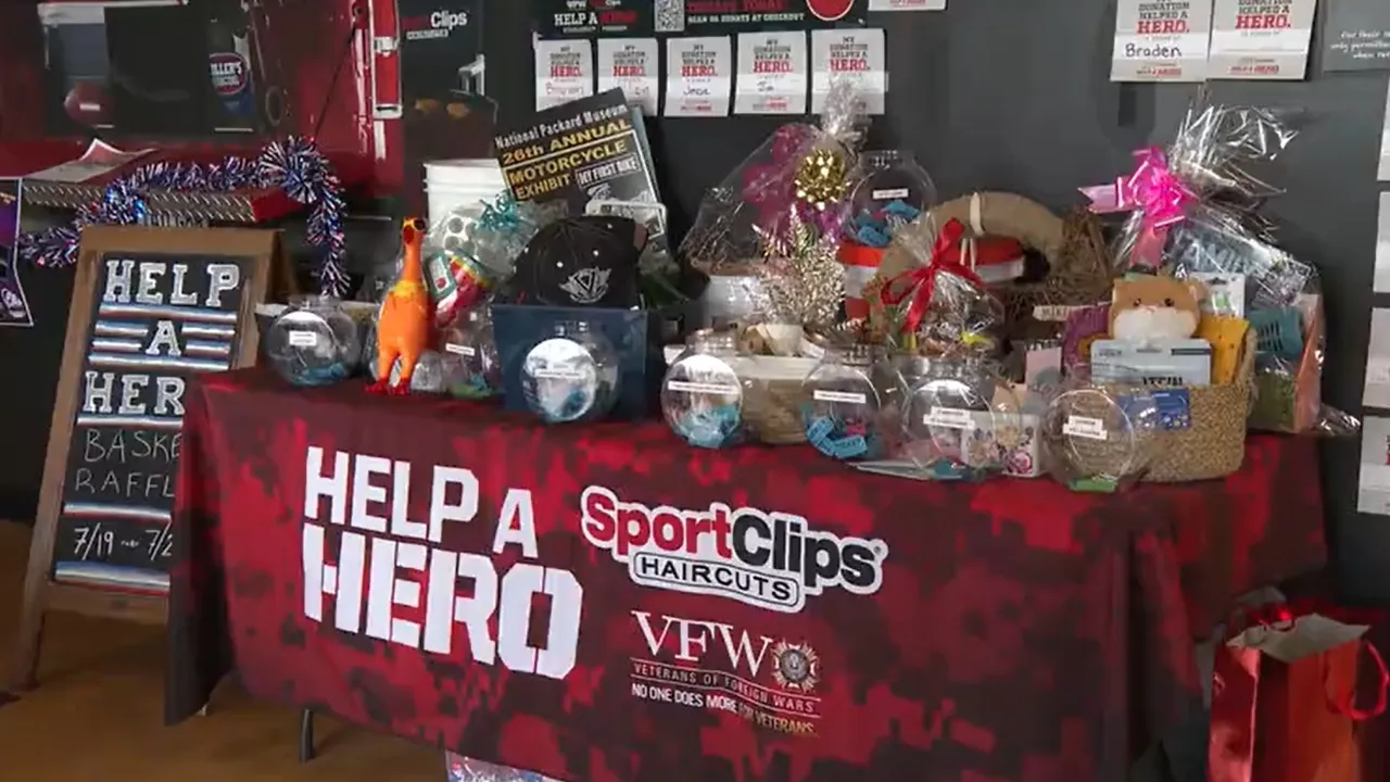 Raffle table promoting "Help a Hero" event with baskets and prizes to support service members' education.